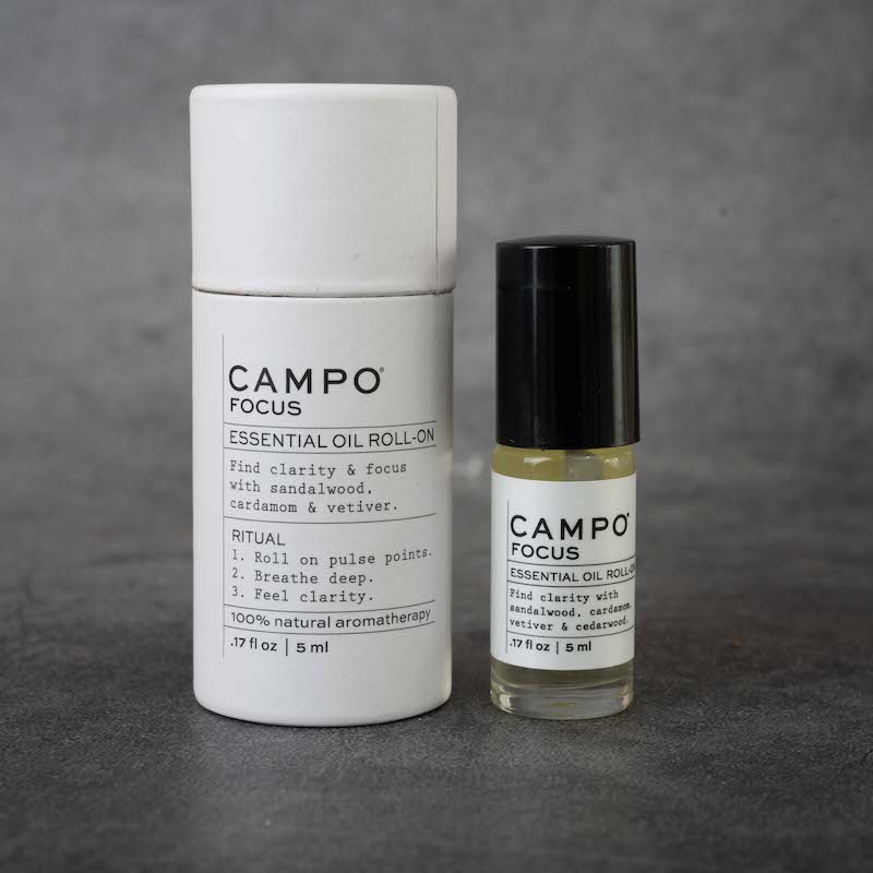 On the left: cylindrical packaging for the CAMPO Focus roll-on. The packaging is white and matches the label on the bottle, and has a pull-off cap. On the right: the same bottle as in the previous picture.