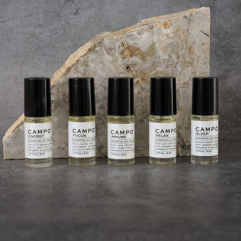 The full CAMPO Essential Oil Roll-on line. From left to right: Energy, Focus, Immune, Relax, Sleep. All Roll-ons are in matching glass bottles.