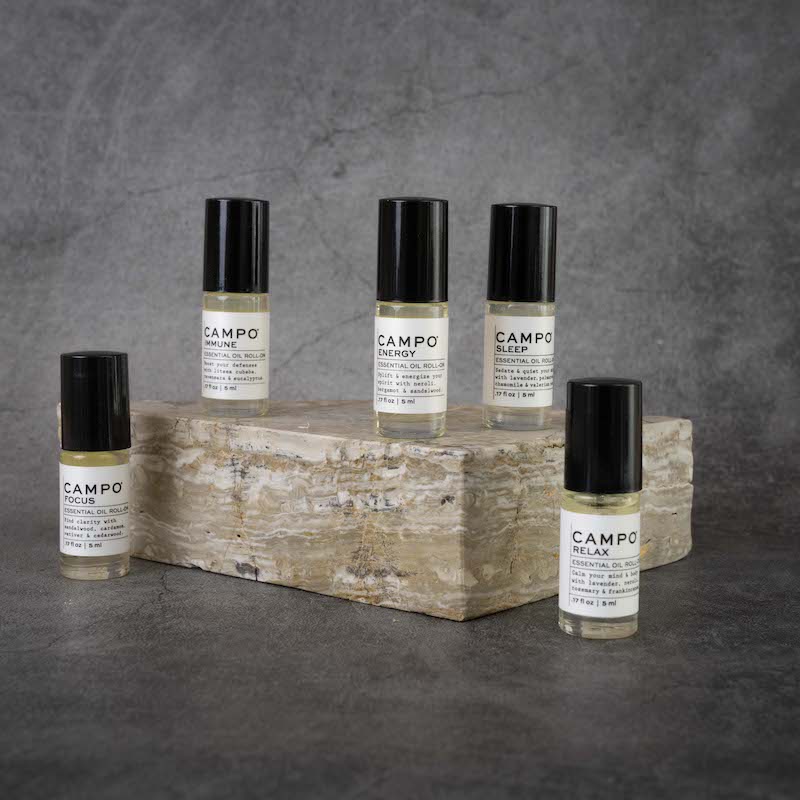 The full CAMPO Essential Oil Roll-on line. From left to right: Focus, Immune, Energy, Sleep, Relax. All Roll-ons are in matching glass bottles.