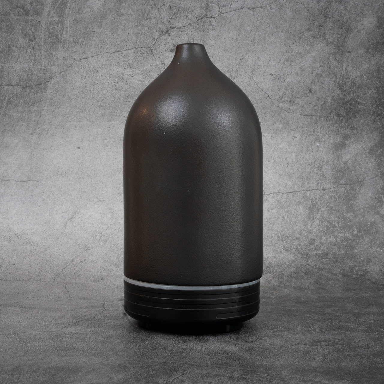 A cone-shaped black essential oil diffuser. 